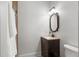 Cozy bathroom with a granite countertop vanity, a framed mirror, and modern toilet at 10603 Low Oak Ter, Thonotosassa, FL 33592