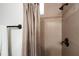 Bathroom with a shower featuring neutral tile and bronze fixtures at 10603 Low Oak Ter, Thonotosassa, FL 33592