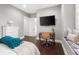 Bedroom with a desk, hardwood floors, and comfortable bed at 10603 Low Oak Ter, Thonotosassa, FL 33592