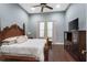 Comfortable bedroom featuring a king-size bed, hardwood floors, and a ceiling fan at 10603 Low Oak Ter, Thonotosassa, FL 33592