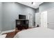 Bedroom featuring hardwood floors, a large tv, and bright natural light at 10603 Low Oak Ter, Thonotosassa, FL 33592
