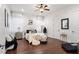 Well-lit bedroom featuring hardwood floors, stylish decor, and comfortable bed at 10603 Low Oak Ter, Thonotosassa, FL 33592