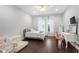 Bright bedroom featuring hardwood floors, a comfortable bed, and a serene view at 10603 Low Oak Ter, Thonotosassa, FL 33592