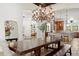 Dining room view showcasing an open layout, elegant chandelier, and connecting living spaces at 10603 Low Oak Ter, Thonotosassa, FL 33592