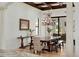 Charming dining room featuring a wooden table, bench seating, and ornate chandelier at 10603 Low Oak Ter, Thonotosassa, FL 33592