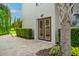 Stylish entrance featuring double doors, travertine pavers, and lush tropical landscaping at 10603 Low Oak Ter, Thonotosassa, FL 33592