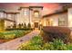Stunning exterior elevation of a luxurious home with manicured landscaping and a brick-paved walkway at 10603 Low Oak Ter, Thonotosassa, FL 33592