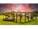 Grand estate illuminated by a vibrant sunset, highlighting its stunning architecture and manicured grounds at 10603 Low Oak Ter, Thonotosassa, FL 33592