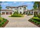 Grand two-story home with circular driveway and manicured landscaping at 10603 Low Oak Ter, Thonotosassa, FL 33592