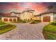 Stunning home exterior with lush landscaping at sunset at 10603 Low Oak Ter, Thonotosassa, FL 33592