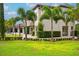 A section of a beautiful home with manicured grass and palm trees at 10603 Low Oak Ter, Thonotosassa, FL 33592