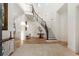 Bright foyer with high ceilings, beautiful staircase, iron railings, and travertine tile floors at 10603 Low Oak Ter, Thonotosassa, FL 33592