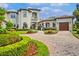 Beautiful home with a two car garage, brick driveway, and immaculate landscaping at 10603 Low Oak Ter, Thonotosassa, FL 33592