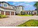Beautiful home with a three car garage, brick driveway, and impeccable landscaping at 10603 Low Oak Ter, Thonotosassa, FL 33592