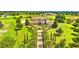 Aerial view of an estate with a long brick driveway and meticulous landscaping at 10603 Low Oak Ter, Thonotosassa, FL 33592