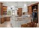 A spacious kitchen features custom cabinets, granite countertops, double islands, and pendant lighting at 10603 Low Oak Ter, Thonotosassa, FL 33592