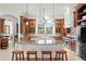 Gourmet kitchen with island, granite countertops, wood cabinets, and stainless steel appliances at 10603 Low Oak Ter, Thonotosassa, FL 33592
