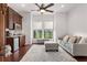 Cozy living room showcasing a comfortable couch, wet bar, and natural light streaming through large windows at 10603 Low Oak Ter, Thonotosassa, FL 33592
