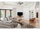 Beautiful living room features large windows, a comfortable sectional sofa, and custom built-in shelving at 10603 Low Oak Ter, Thonotosassa, FL 33592