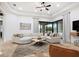 The living room features a sectional sofa, a modern ceiling fan, and large sliding glass doors at 10603 Low Oak Ter, Thonotosassa, FL 33592