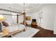 Elegant main bedroom with four-poster bed, sitting area, and ample natural light at 10603 Low Oak Ter, Thonotosassa, FL 33592