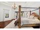 Opulent main bedroom with a four-poster bed, chandelier, and private outdoor access at 10603 Low Oak Ter, Thonotosassa, FL 33592