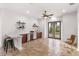Spacious recreation room with a bar, tile floors, ceiling fan, and access to the backyard at 10603 Low Oak Ter, Thonotosassa, FL 33592