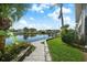 Serene backyard with a canal view, lush landscaping, and a paver patio at 1661 Watermark Ne Cir # C, St Petersburg, FL 33702