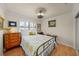 Cozy bedroom with vintage furniture, wood floors, and natural light from the window at 1661 Watermark Ne Cir # C, St Petersburg, FL 33702