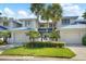 Charming townhouse with a two-car garage, a manicured lawn and lush tropical landscaping at 1661 Watermark Ne Cir # C, St Petersburg, FL 33702