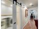 Hallway featuring a frosted sliding door to laundry room and artwork at 1661 Watermark Ne Cir # C, St Petersburg, FL 33702