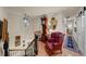 Cozy landing area featuring a red leather armchair, antique grandfather clock, and decorative lighting at 1661 Watermark Ne Cir # C, St Petersburg, FL 33702