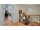Elegant staircase with wood floors and wrought iron railings, leading to the second floor at 1661 Watermark Ne Cir # C, St Petersburg, FL 33702