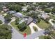 Aerial view of a property with solar panels on the roof and a swimming pool in the backyard at 411 Harbor View Ln, Largo, FL 33770
