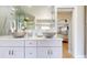 Bathroom showcasing double vessel sinks, sleek white cabinets, and contemporary fixtures at 411 Harbor View Ln, Largo, FL 33770
