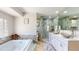 Well-lit bathroom featuring a soaking tub, stylish shower, and double vanity at 411 Harbor View Ln, Largo, FL 33770