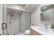 Bathroom featuring a glass enclosed shower with marble tiling, a toilet, and a sink at 411 Harbor View Ln, Largo, FL 33770