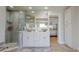 Elegant bathroom featuring double vanities, a glass-enclosed shower, and neutral tiling at 411 Harbor View Ln, Largo, FL 33770