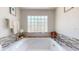 Bright bathroom with a relaxing bathtub and decorative glass block window at 411 Harbor View Ln, Largo, FL 33770