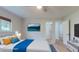 Virtually staged bedroom featuring a window view, mounted tv, and queen sized bed at 411 Harbor View Ln, Largo, FL 33770