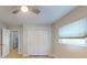 Bright bedroom with neutral walls, closet, and a window allowing natural light to fill the space at 411 Harbor View Ln, Largo, FL 33770