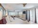 Bright bedroom features a ceiling fan, shuttered windows, and a door to the outside at 411 Harbor View Ln, Largo, FL 33770
