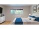 Virtually staged bedroom featuring a window view, dresser, and queen sized bed at 411 Harbor View Ln, Largo, FL 33770
