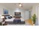 Virtually staged bedroom with ceiling fan, rug, television, and queen bed at 411 Harbor View Ln, Largo, FL 33770
