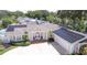 Beautiful house with solar panels on the roof, lovely landscaping, and an American flag at 411 Harbor View Ln, Largo, FL 33770