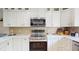 Modern kitchen featuring stainless steel appliances, sleek white cabinetry, and beautiful countertops at 411 Harbor View Ln, Largo, FL 33770