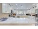 Bright kitchen features white cabinetry, stainless steel appliances, and ample countertop space at 411 Harbor View Ln, Largo, FL 33770