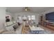Comfortable living room featuring plush seating, modern fireplace and an open layout at 411 Harbor View Ln, Largo, FL 33770