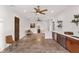 Open concept kitchenette with island, cabinets and tile floors at 10603 Low Oak Ter, Thonotosassa, FL 33592
