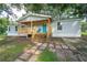 Inviting covered porch with a vibrant turquoise door, perfect for relaxing and enjoying the outdoors at 12106 Dagwood Way, Riverview, FL 33579